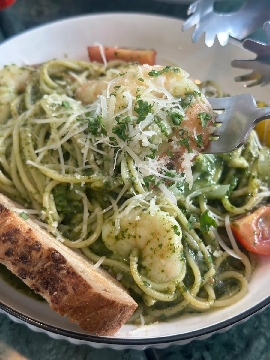 Twirling up the noodles of the basil pesto pasta