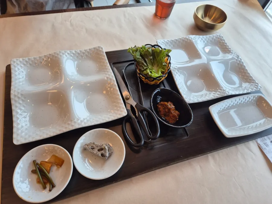 Full table spread with grilled fish, pot rice, and side dishes