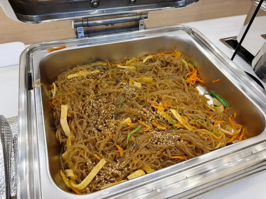 Variety of side dishes including stir-fried pork at the self-serve bar