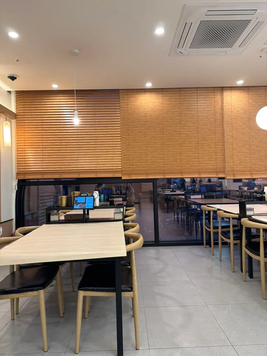 Store interior with signage about the 15-dish all-you-can-eat Korean side bar