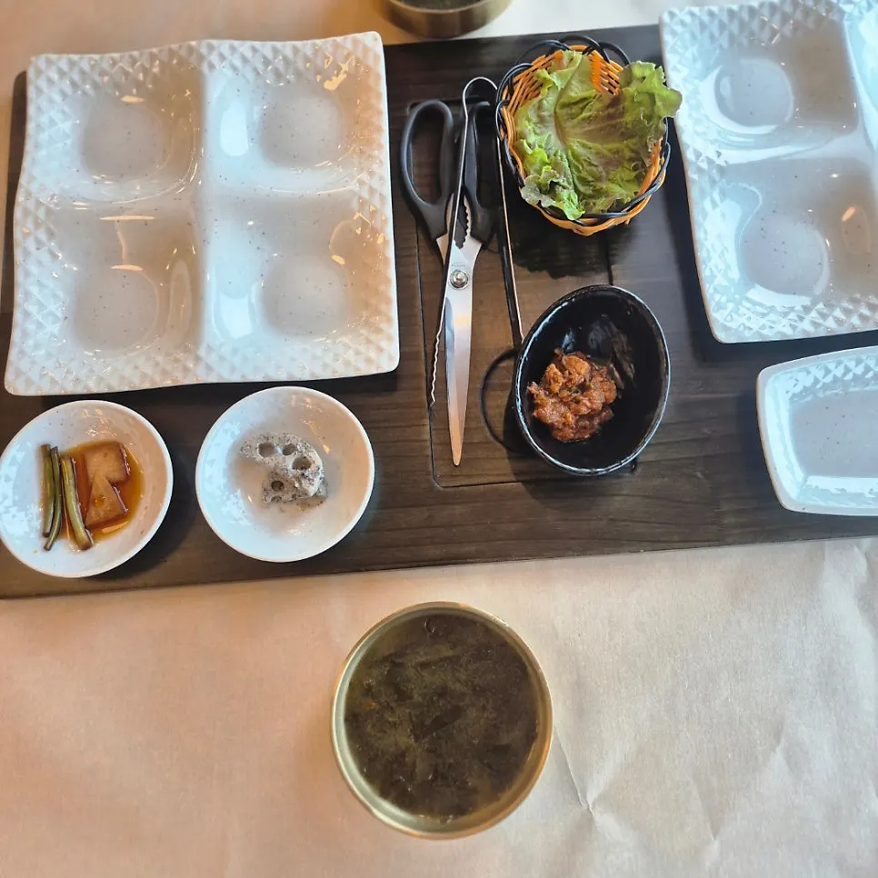 Seaweed soup, lettuce, and side dishes on the table