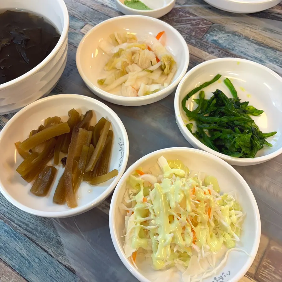 Salad, white kimchi, and pickled vegetable side dishes
