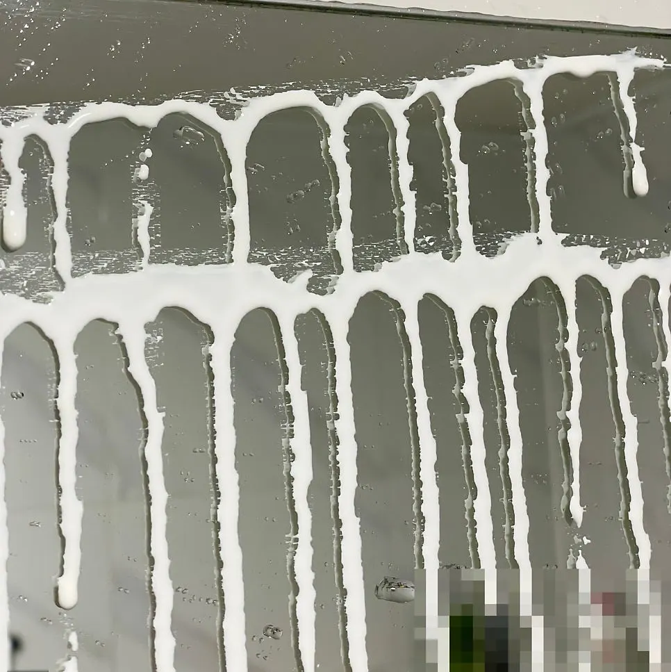 Applying oil-film remover to a bathroom mirror