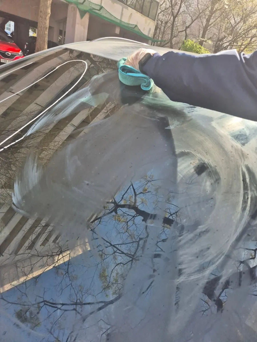 Applying Clean View oil-film remover to car glass