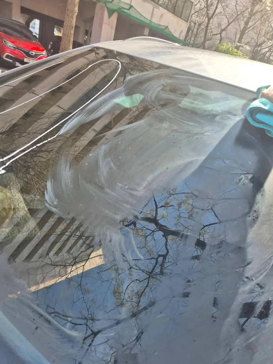 Oil-film remover solution spread white across car glass