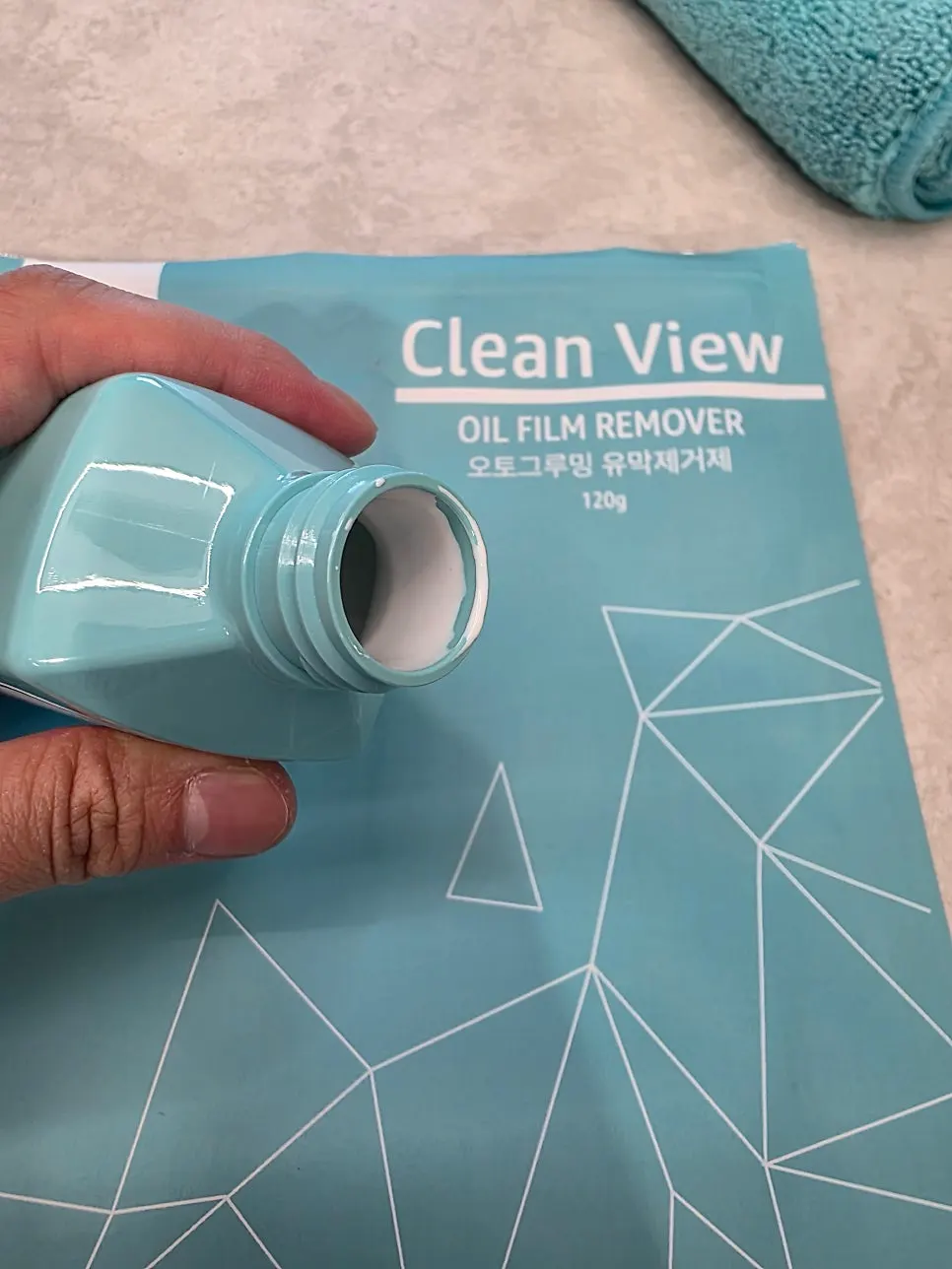 Spraying CleanView and wiping the glass with the dedicated towel