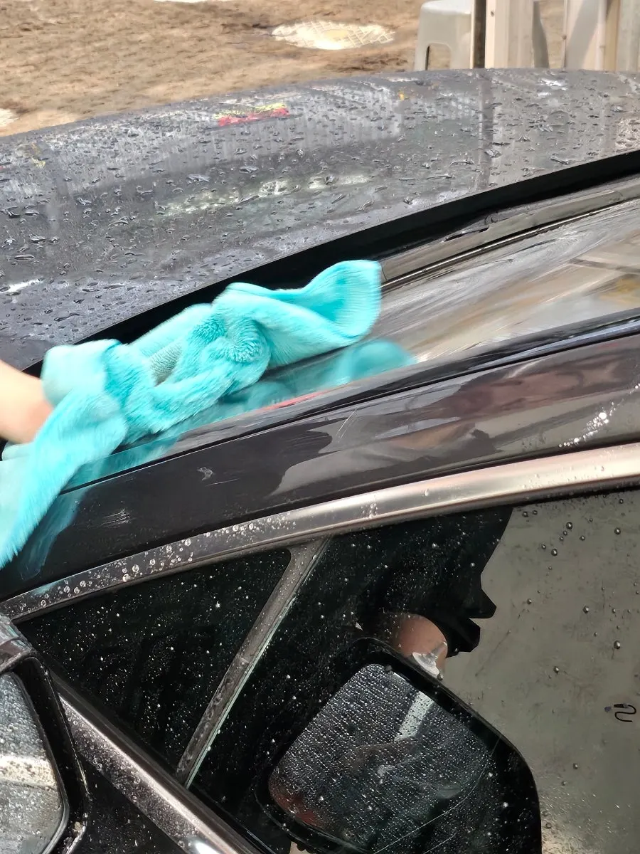Car glass oil film removal being rinsed with water