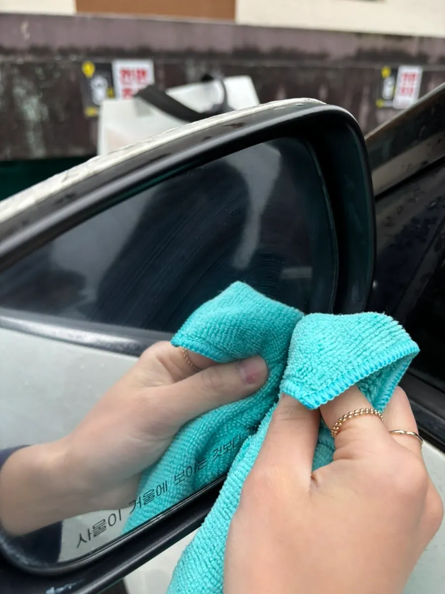 Car glass with film remover applied broadly