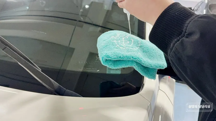 Wiping oil film from car glass with a towel