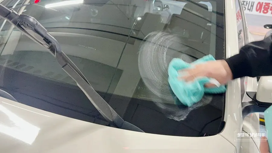 Cleaning car glass with the included dedicated towel