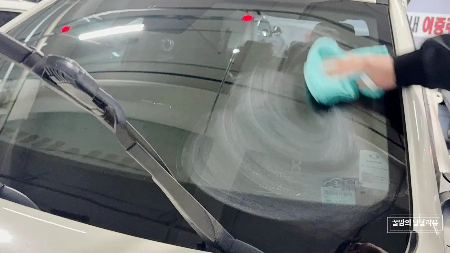 Car glass being treated for oil film removal with Clean View