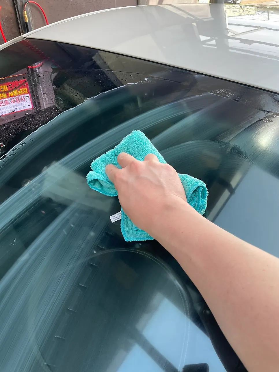 Applying Clean View oil-film remover to car glass