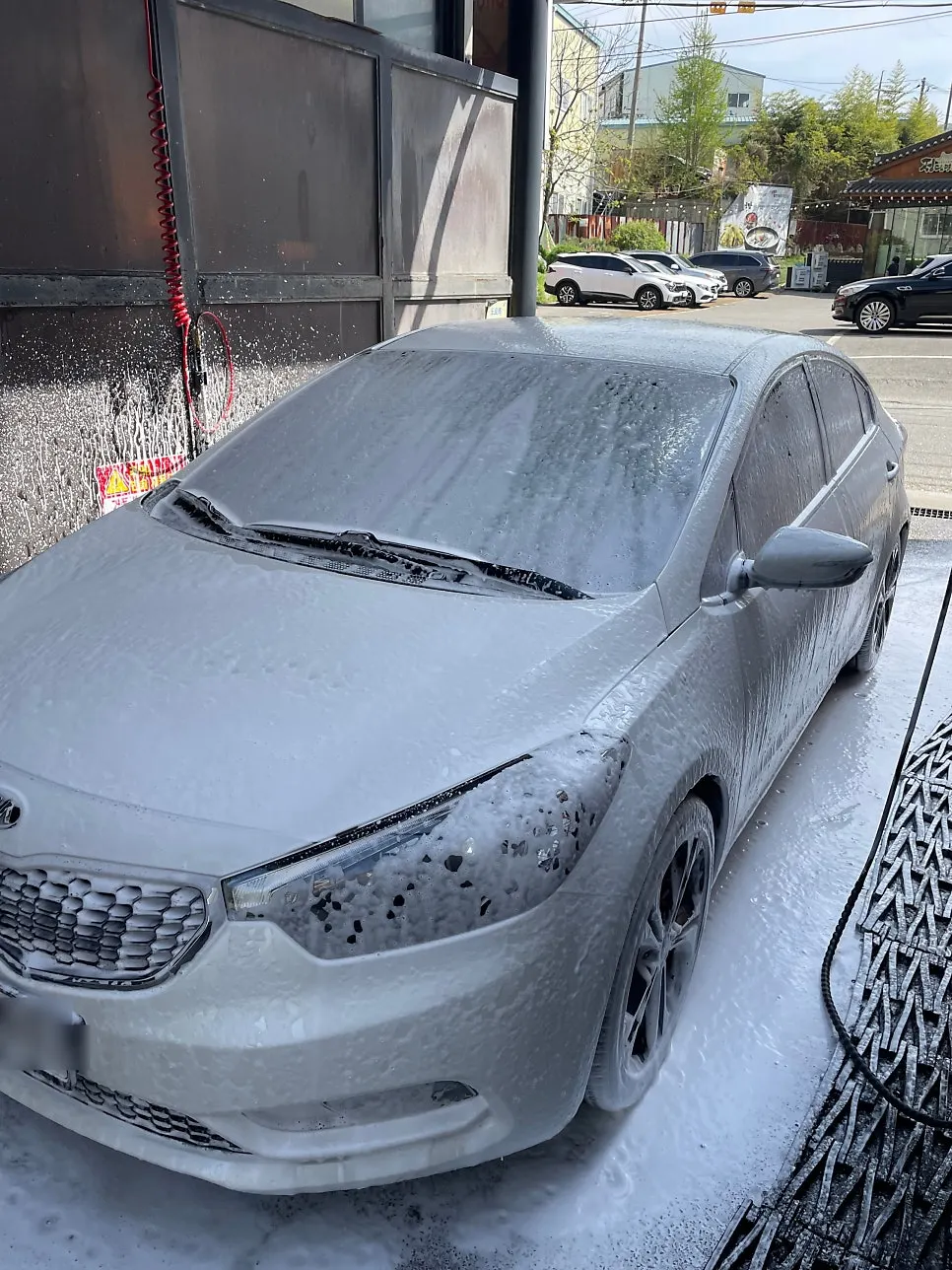 Car glass with oil-film remover spread broadly using a large cloth