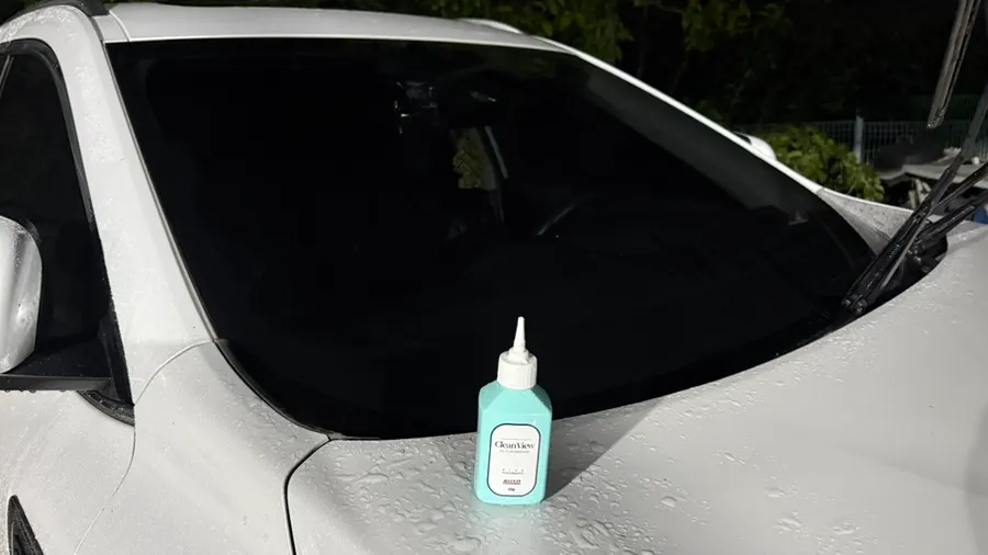 Car glass rinsed with water after scrubbing with oil film remover
