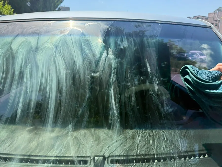 Wiping car glass before rinsing with water