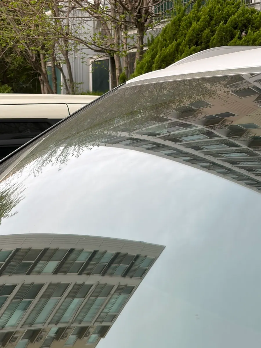 Car windshield before oil film removal