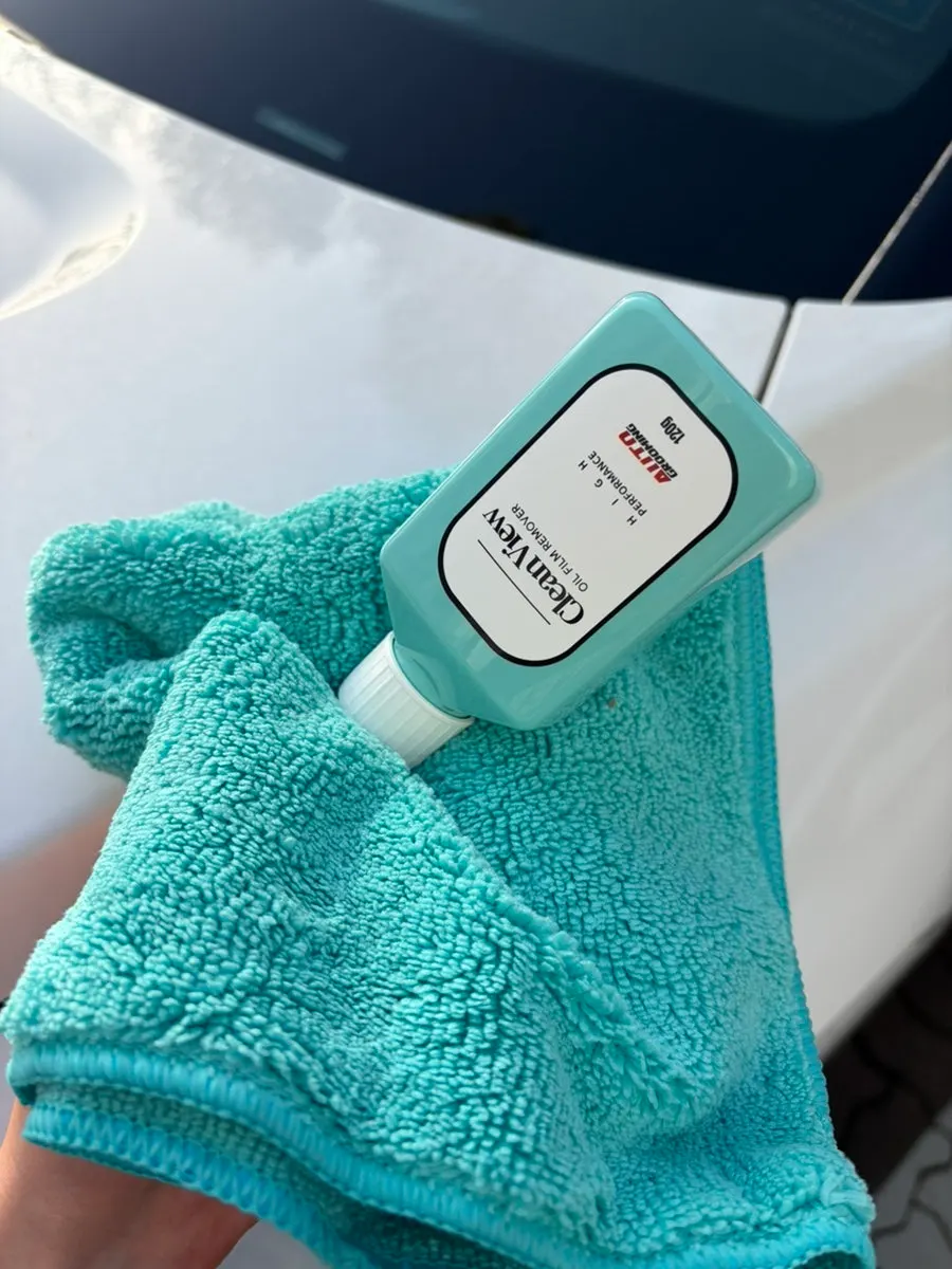 Applying oil film remover to a microfiber cloth