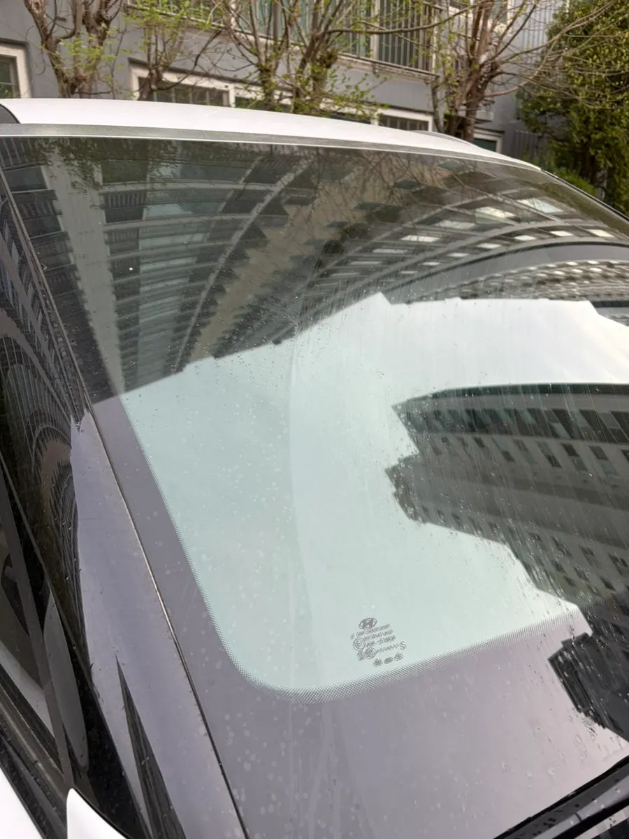 Car windshield before oil film removal
