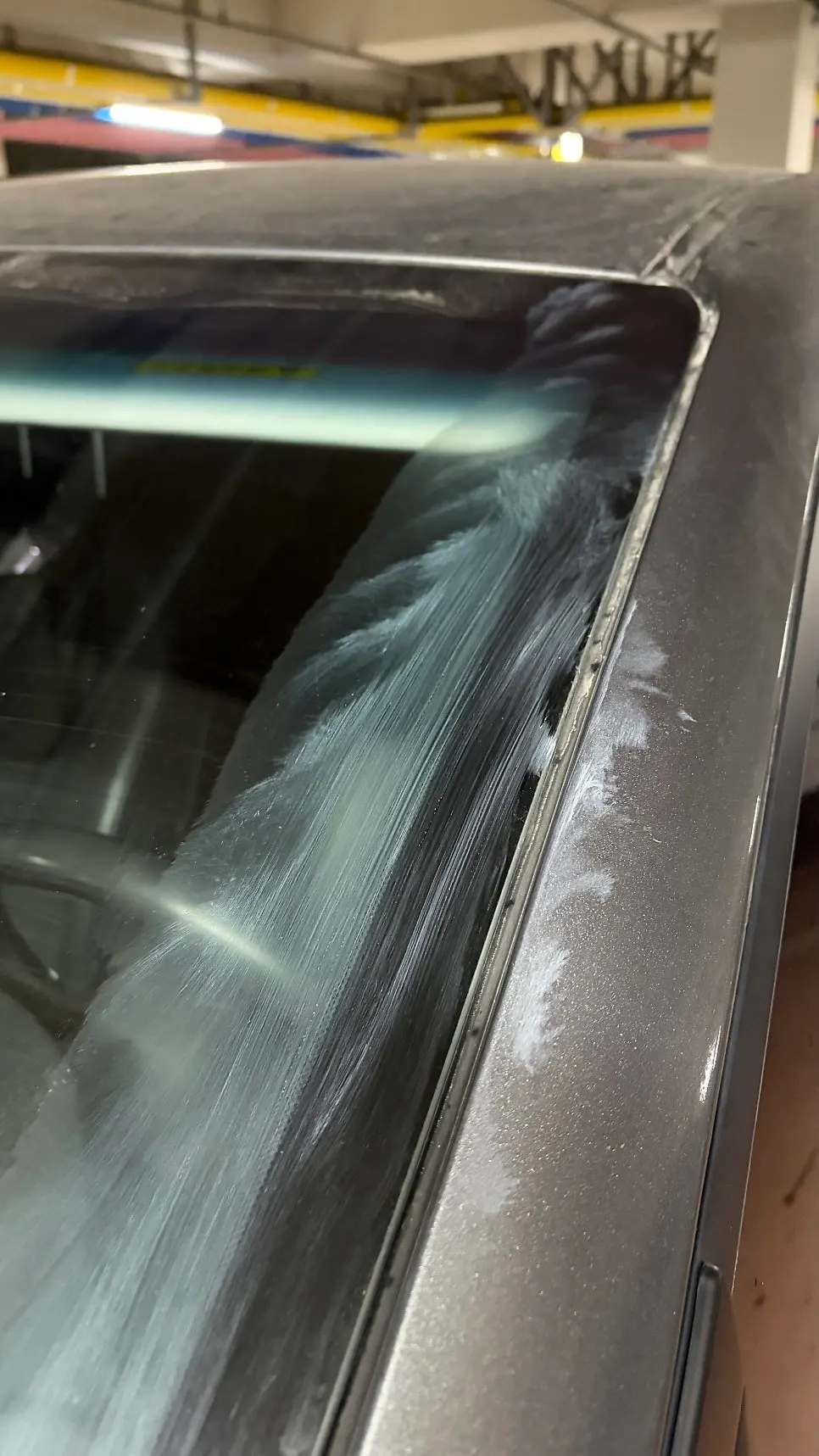 Edge of car glass cleaned with oil-film remover