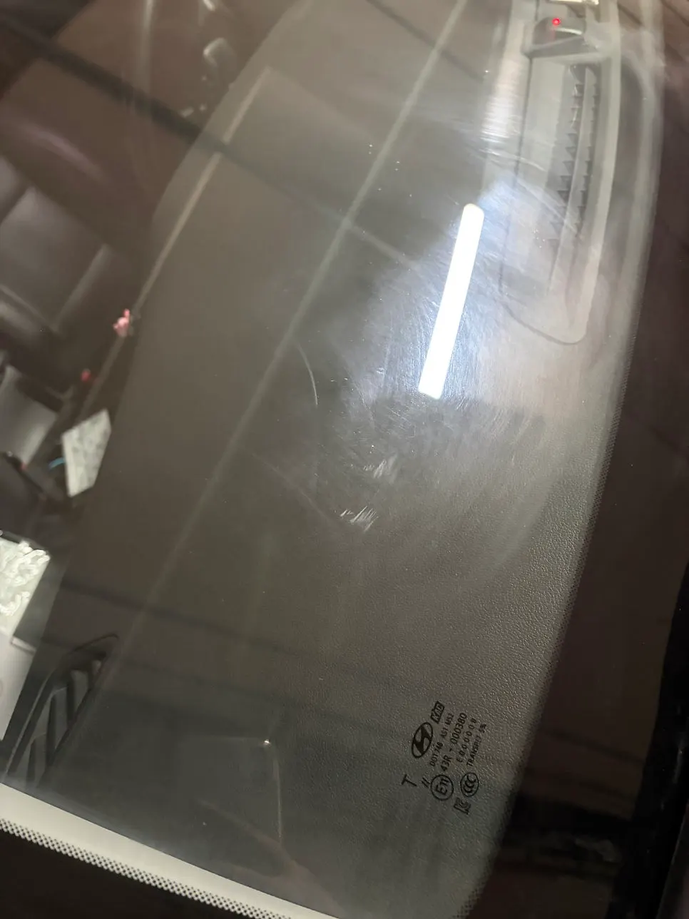 Front windshield after wiping with a towel in the parking garage
