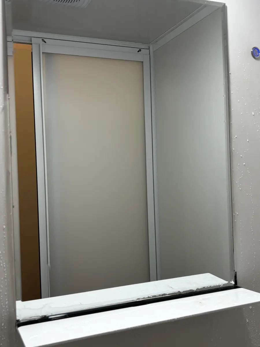 Beauty shop washroom mirror after rinsing off the oil-film remover