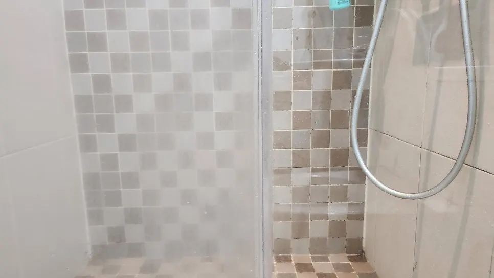 Shower glass with cloudy film cleared away