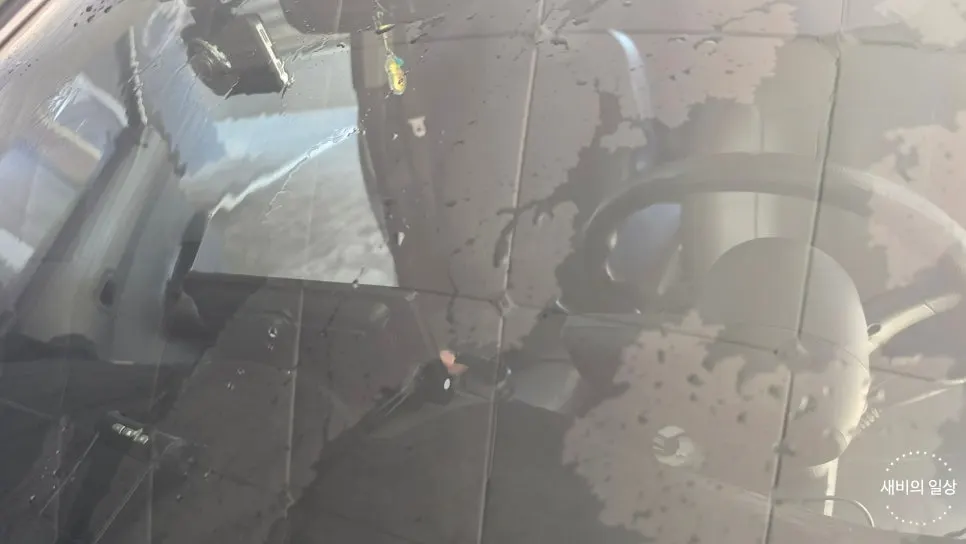 Washing dust and debris from a windshield before oil-film removal