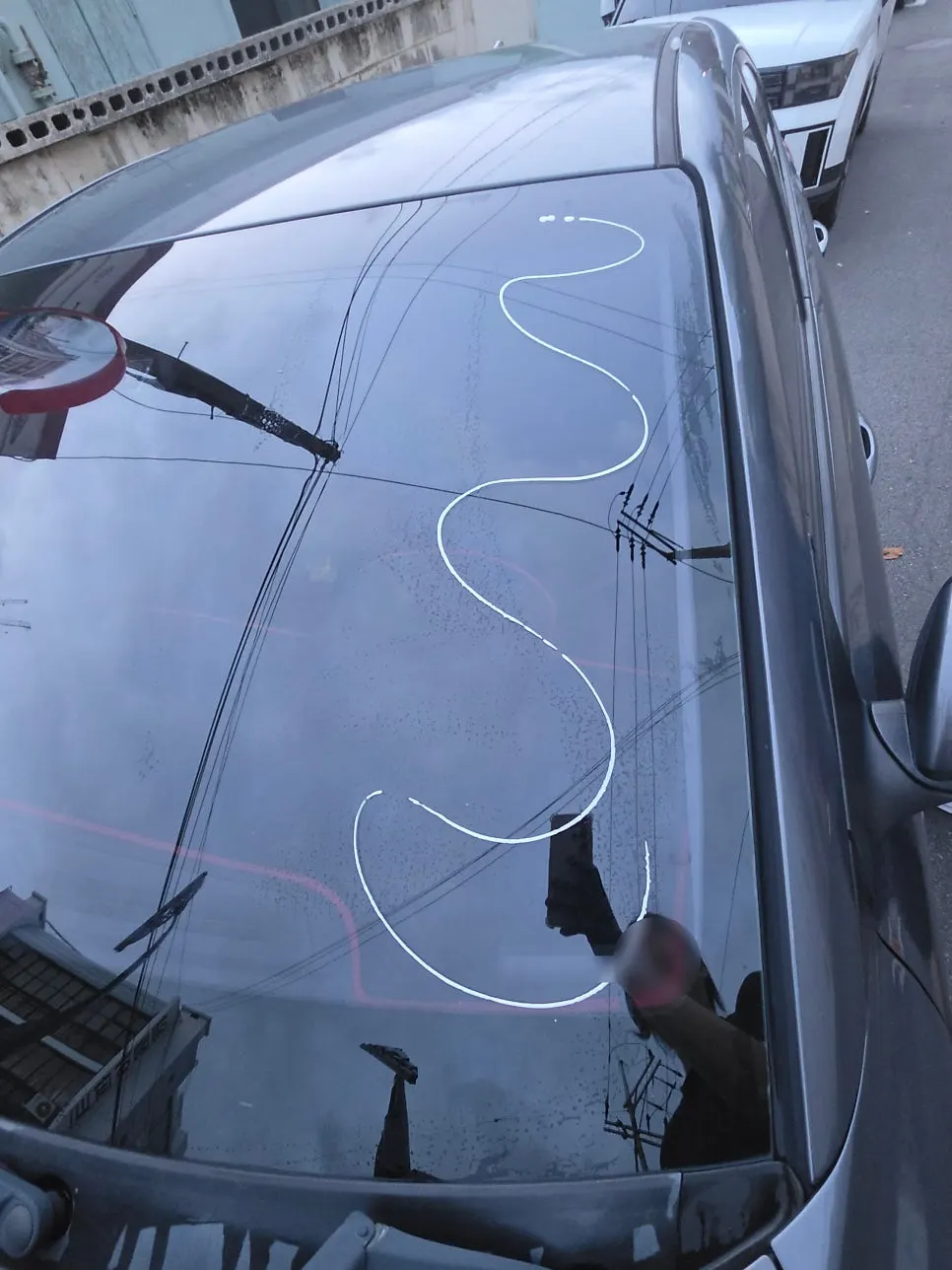 Process of removing oil film from a car windshield with Clean View