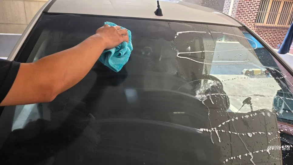 Wiping a solution-covered windshield with a towel
