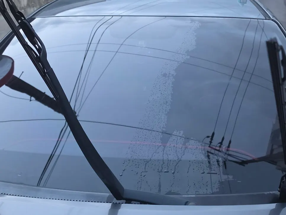Windshield surface condition by treated and untreated oil-film removal areas