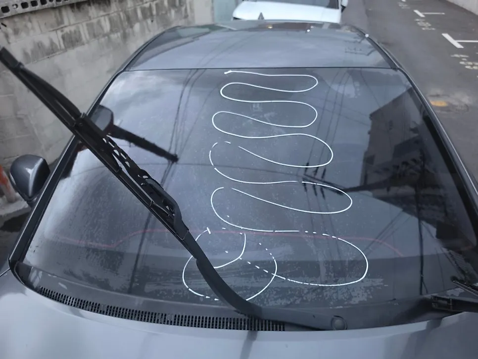 Car windshield compared by spraying water on the surface