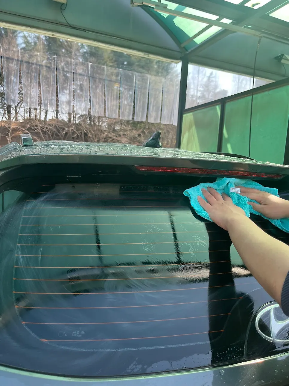 Car washed with foam and water after oil film removal