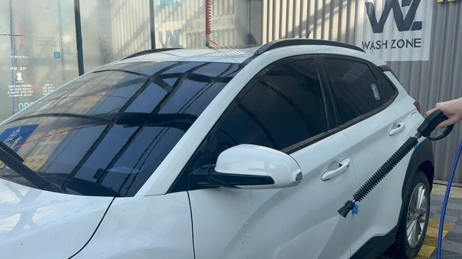 Car windshield rinsed with water after using oil film remover