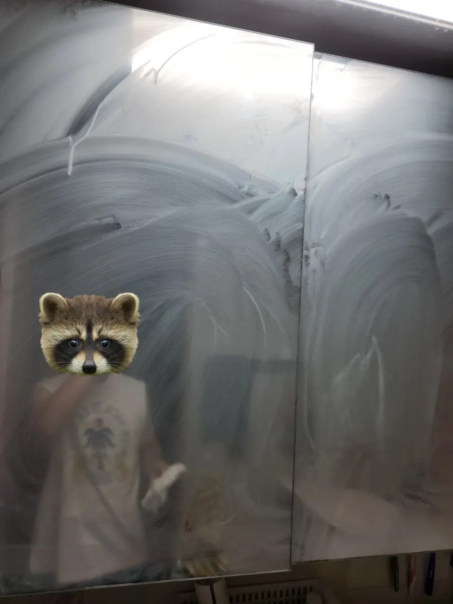 Rubbing oil-film remover across the lower bathroom surface