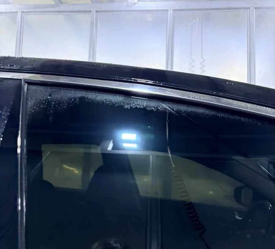 Glass surface after rinsing off oil-film remover at a self-service car wash