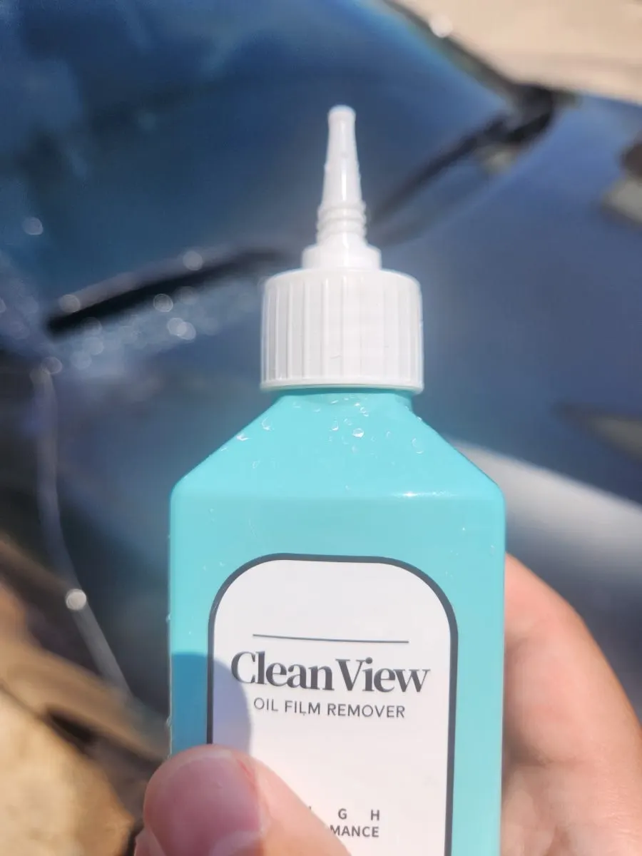 Car windshield sprayed with water before oil-film removal