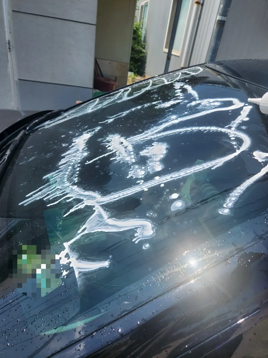 Applying oil-film remover to a car windshield