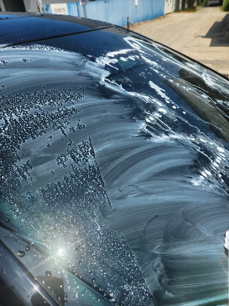 Rubbing a car windshield with a separate cloth