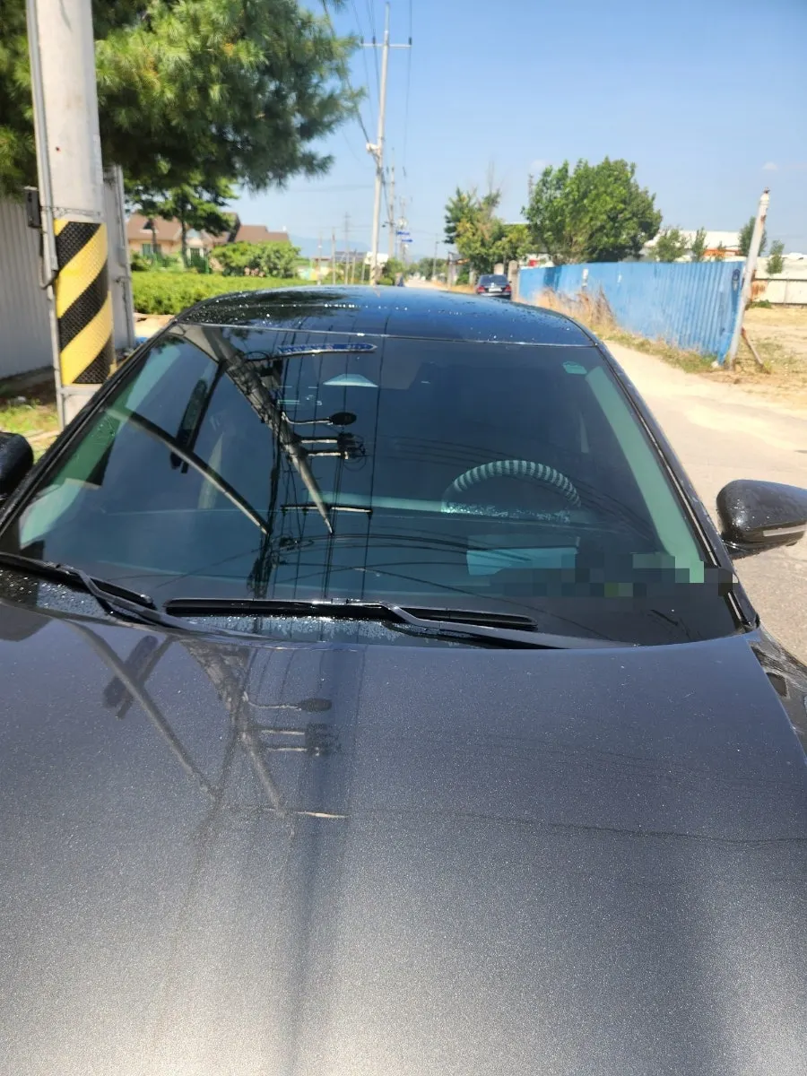 Spraying water onto a car windshield to rinse it