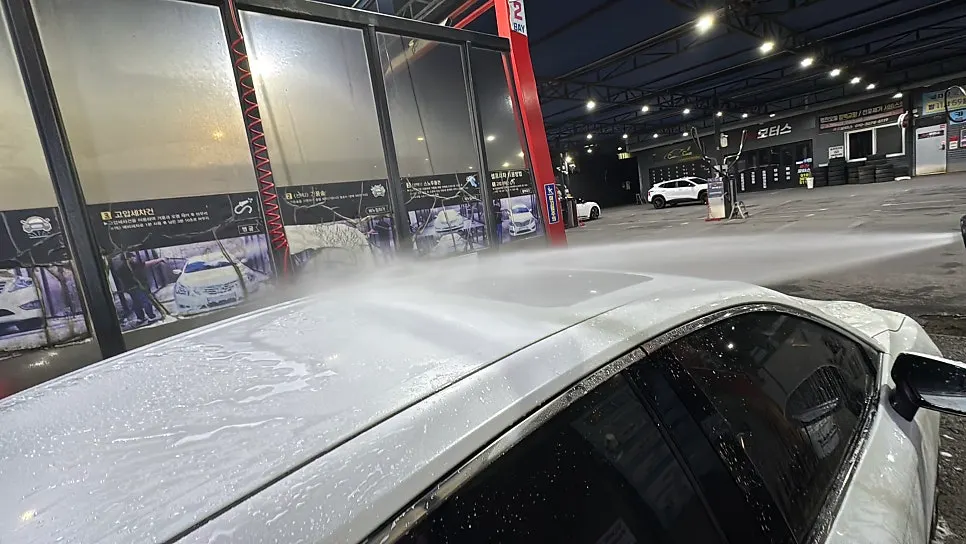 Checking the paintwork for remaining grime after a high-pressure rinse