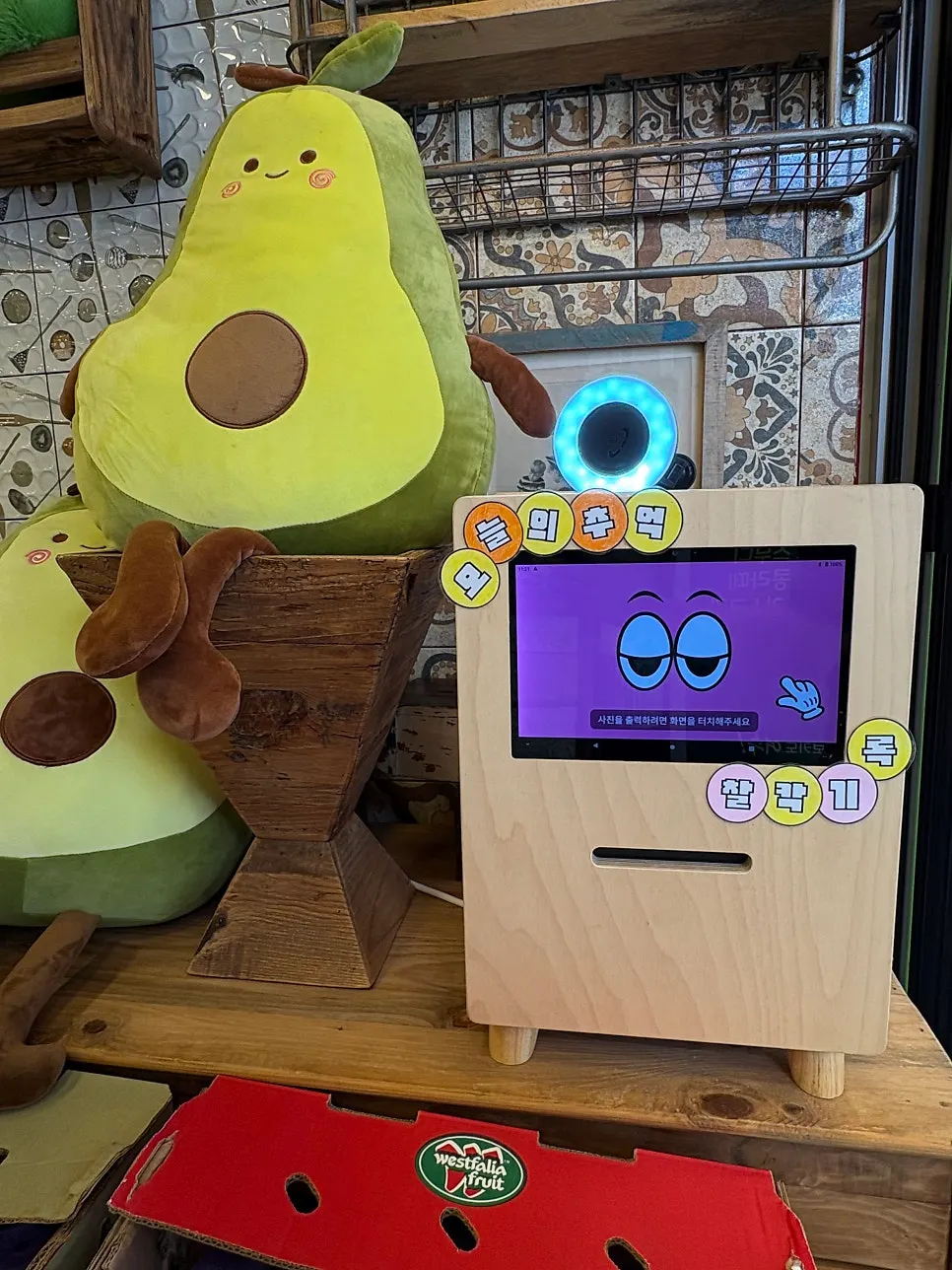 Photo booth machine and photos displayed near the entrance