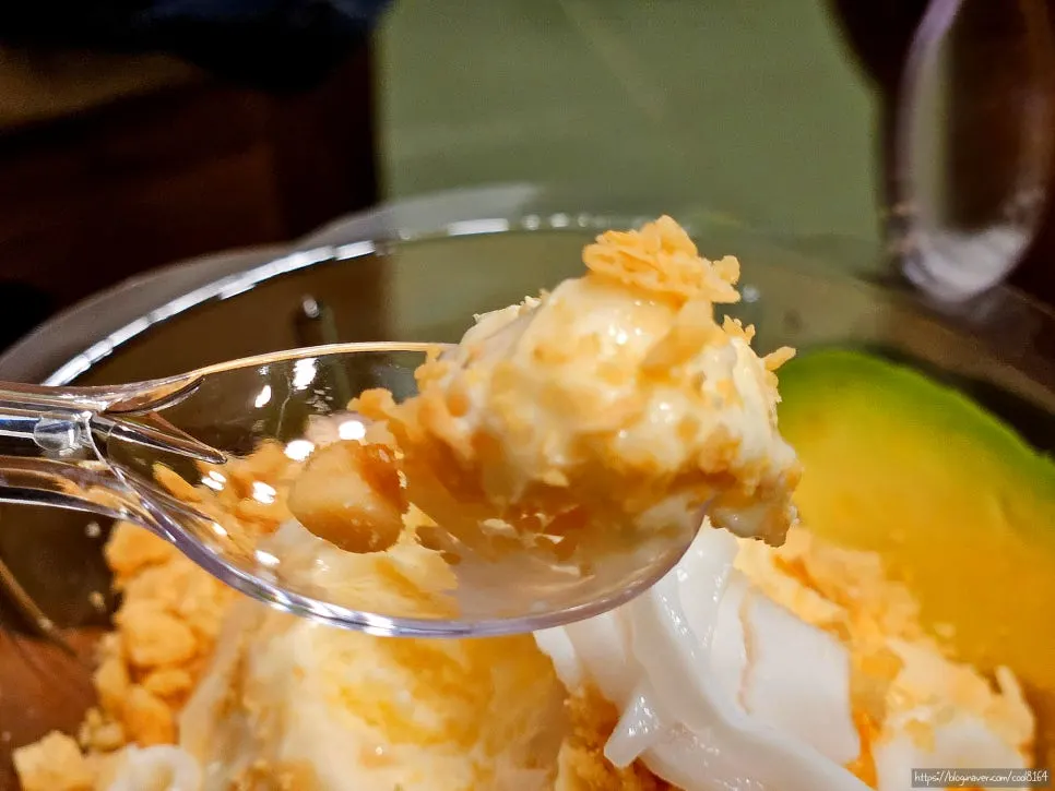 Cross-section of ice cream topped with avocado and coconut