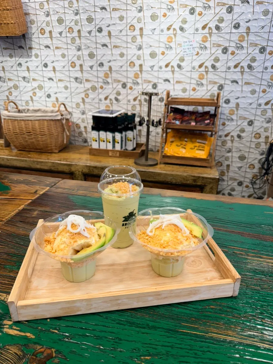 Ice cream topped with two slices of fresh avocado