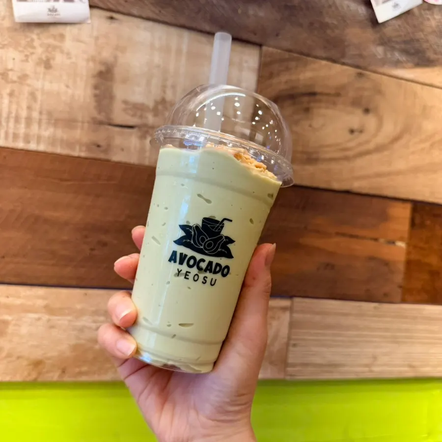 A glass of green avocado slushie