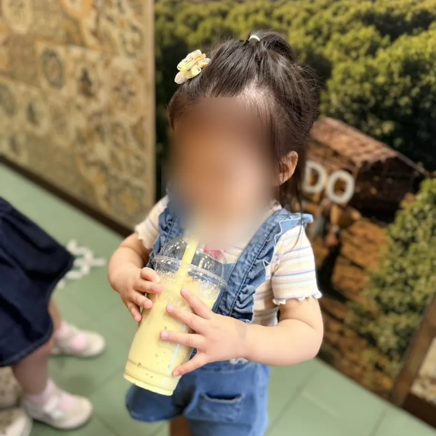 A child drinking the avocado slushie
