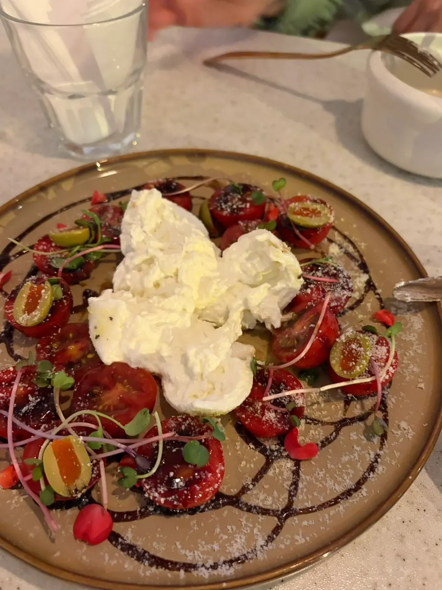 Burrata cheese quartered with cherry tomatoes