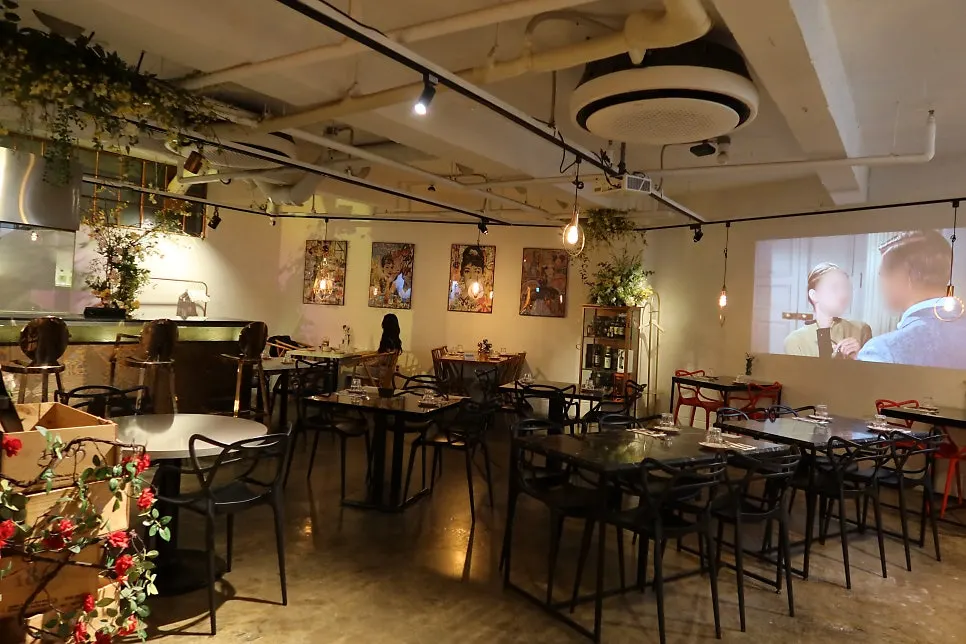 The interior of Awesome Rose with red roses and warm lighting