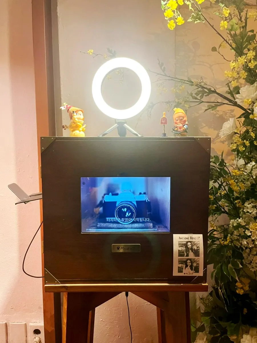 Black-and-white photo booth on one side of the restaurant