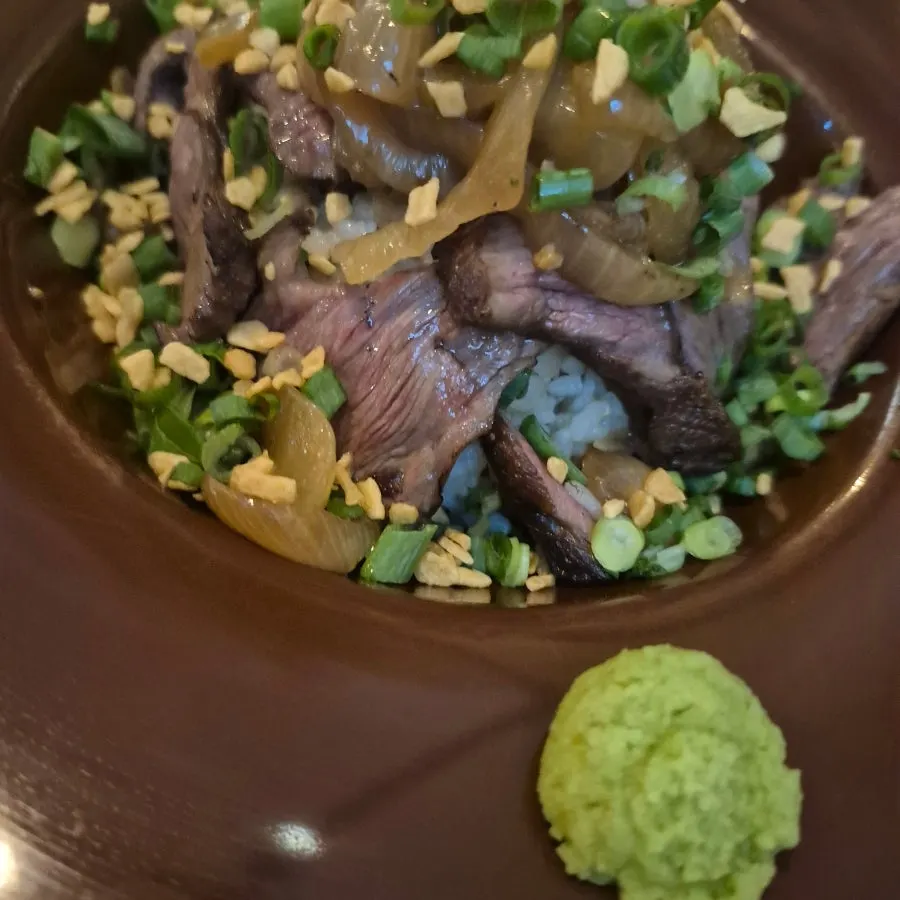 Table spread with pasta and the steak rice bowl together