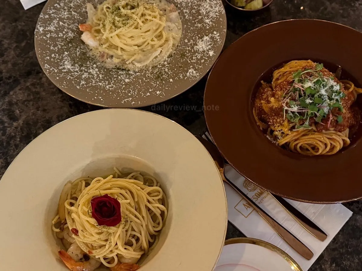 Three plates of pasta set out on the table at Awesome Rose